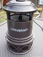 Front view of Dynatrap XL mosquito trap showing top on/off switch, body with logo, and lattice bottom section.