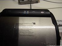 Top view of FoodSaver Vacuum Sealer V2840 showing stainless steel and black design with control buttons and brand logo.