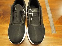 Top view of Adidas CloudForm running shoes displaying black mesh uppers, Adidas logo on tongue, no laces present