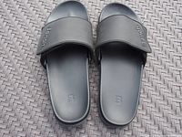 Top-down view of the black Bench slide sandals showing the strap and footbed branding.