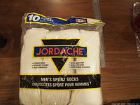 Front of unopened 10-pack Jordache men's sport socks in plastic packaging with branding and features visible.