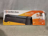 Photo of the boxed Comfort Zone digital baseboard heater showing brand name, product image, and model number CZ650B