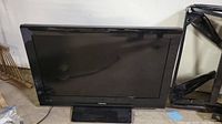 Front view of Toshiba 32-inch flat screen TV showing the screen and the base stand.