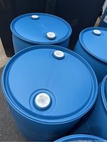 Top view showing the white screw-on caps on the blue plastic rain barrels.