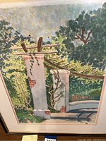 Photo of original watercolor painting titled 'Garden Gate' showing garden columns and greenery.
