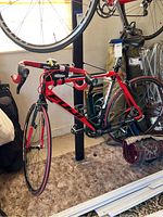 Full side view showing red and black Fuji frame on display stand