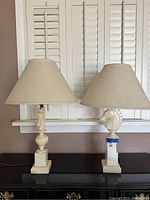 Pair of two Italian marble horse head lamps with cream paisley patterned shades, front view.