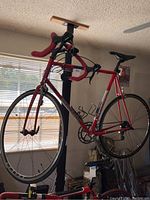 Full side view of the red Lemond bike on a stand showing frame, wheels, and saddle