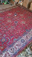 Full view of red Persian area rug on floor