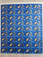 Full sheet of blue Mongolian stamps featuring space monkey and satellite imagery, with pre-cancelled postmarks