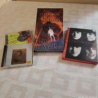 Overview photo of four music-related items: Moody Blues Time Traveller box set, Beatles A Hard Day's Night movie/CD, BB King CD, Blues Traveller CD