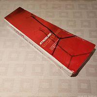 Box of Stageline adjustable guitar stand showing front with image of stand