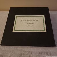 Black folder labeled 'INNER-VIEW "The Doors" PARTS I-IV' containing the vinyl set.