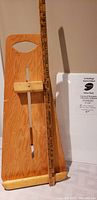 Photo of natural wood easel alongside a yardstick showing 29 inches height