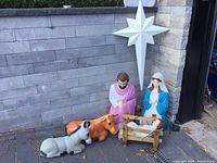 All Nativity pieces displayed outdoors against stone wall