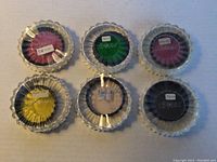 Six camera filters in clear plastic cases showing various colors and size markings. Five marked as TIFFEN 52mm and one as 58mm.