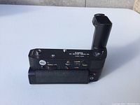 Side view of Canon AE Motor Drive FN showing textured black grip, buttons, and dials for winding and film counter.