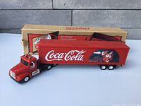 Full length of Coca Cola Christmas transport in front of original box.