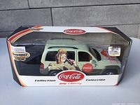 Front view of boxed Matchbox Jeep Liberty with Coca Cola branding showing box condition and item inside