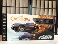 Front of box showing main product and two Fast & Furious cars in blister pack