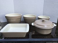 Photo showing entire set of six Nest Stoneware pieces including nested bowls, casserole dish with lid, and baking dish.