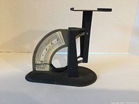 Front side view of Wadico Pennyweight Postal Scale, showing the scale dial with measurement markings and weighing arm.