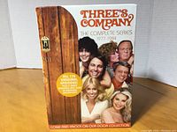 Front view of the sealed Three's Company complete DVD series box showing cast and title.