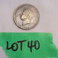 Front side of the 1827 British silver shilling coin displaying King George IV portrait and inscriptions.