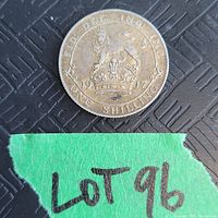 Front side of the 1917 British silver one shilling coin showing the crowned lion and crown with inscriptions and year.