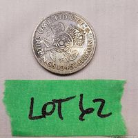 Close-up of the 1945 British two pence coin showing the front with floral and crown emblem and inscriptions.