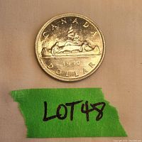 Photo of the reverse side of the 1950 Canada silver dollar showing the Voyageur design.