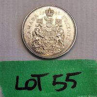 Front side (reverse) of the 1962 Canadian 50 cent silver coin showing the Canadian Coat of Arms and denomination.