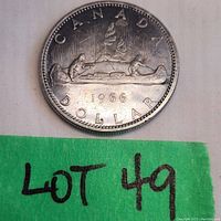 1966 Canadian silver dollar coin featuring the Voyageur design, front side showing design and date.