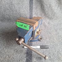 Light duty 4 inch swivel vise shown, with visible rust and paint chipping. Marker placed for scale.