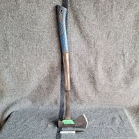 Full view of the 26-inch Estwing camping hatchet standing against a gray background next to a sharpie marker for scale.