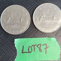 Pair of 1978 Canadian one dollar coins showing both front sides with Voyageur design and date detail.