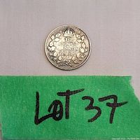 Reverse side of silver Canadian 1937 10 cent coin showing denomination and crown with wreath.