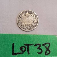 Close-up photo of 1916 Canadian 10 Cent coin front side showing denomination and year with wreath.