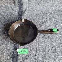 Top-down view of the 6-inch cast iron pan showing the cooking surface and two pour spouts.