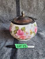Front view of the Victorian biscuit jar showing hand painted floral design and silver plated lid with decorative handle.