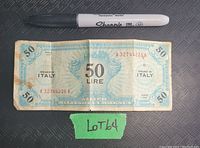 Front view of the 50 Lire Allied Military currency note with a Sharpie marker showing scale