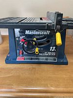 Front view of the Mastercraft 10-inch table saw showing brand, motor specs and controls.