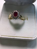 Ring viewed head-on in box against white padded background