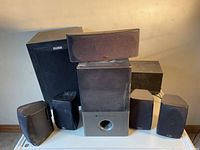 Photo of front view of all Polk Audio speakers including subwoofer and satellite speakers