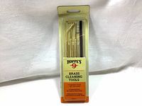 Photo of front packaging showing the 4-piece brass cleaning set with three picks and one brush visible inside plastic blister pack.