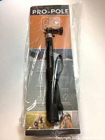 Front view of the GO case PRO-POLE selfie stick monopod in packaging with product branding and key features.