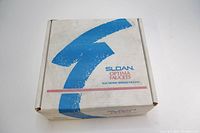 Closed white cardboard box with Sloan Optima Faucets branding and electronic sensor faucet indication.