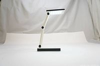 Photo of the portable folding LED desk lamp in a folded position showing its compact design and the LED panel.