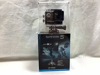 Front view of Safari 5 action camera inside its display and packaging box.