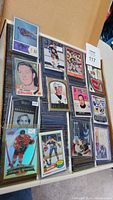 Open box showing top-loaded hockey cards including Fred Stanfield Bruins, Ken Hodge, Glenn Hall, Select Honored Selections, Blackhawks refractor and Oilers bubble card.